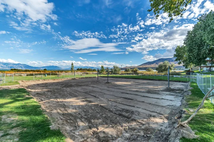 Expansive cleared lot with perimeter fencing and visible utility posts