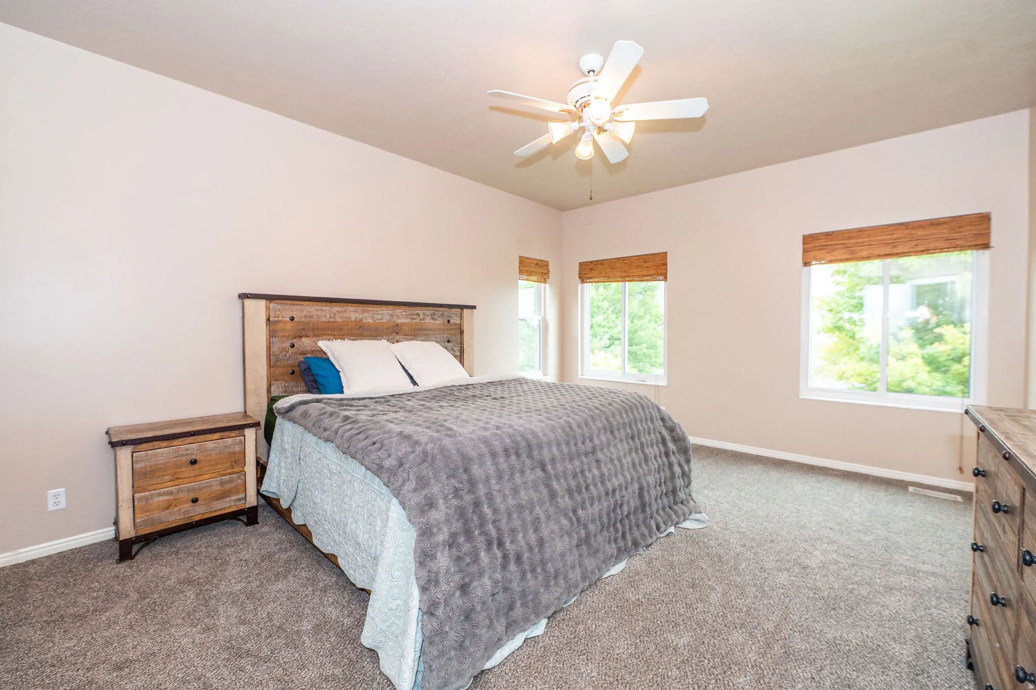 Room featuring neutral wall tones and textured carpet flooring