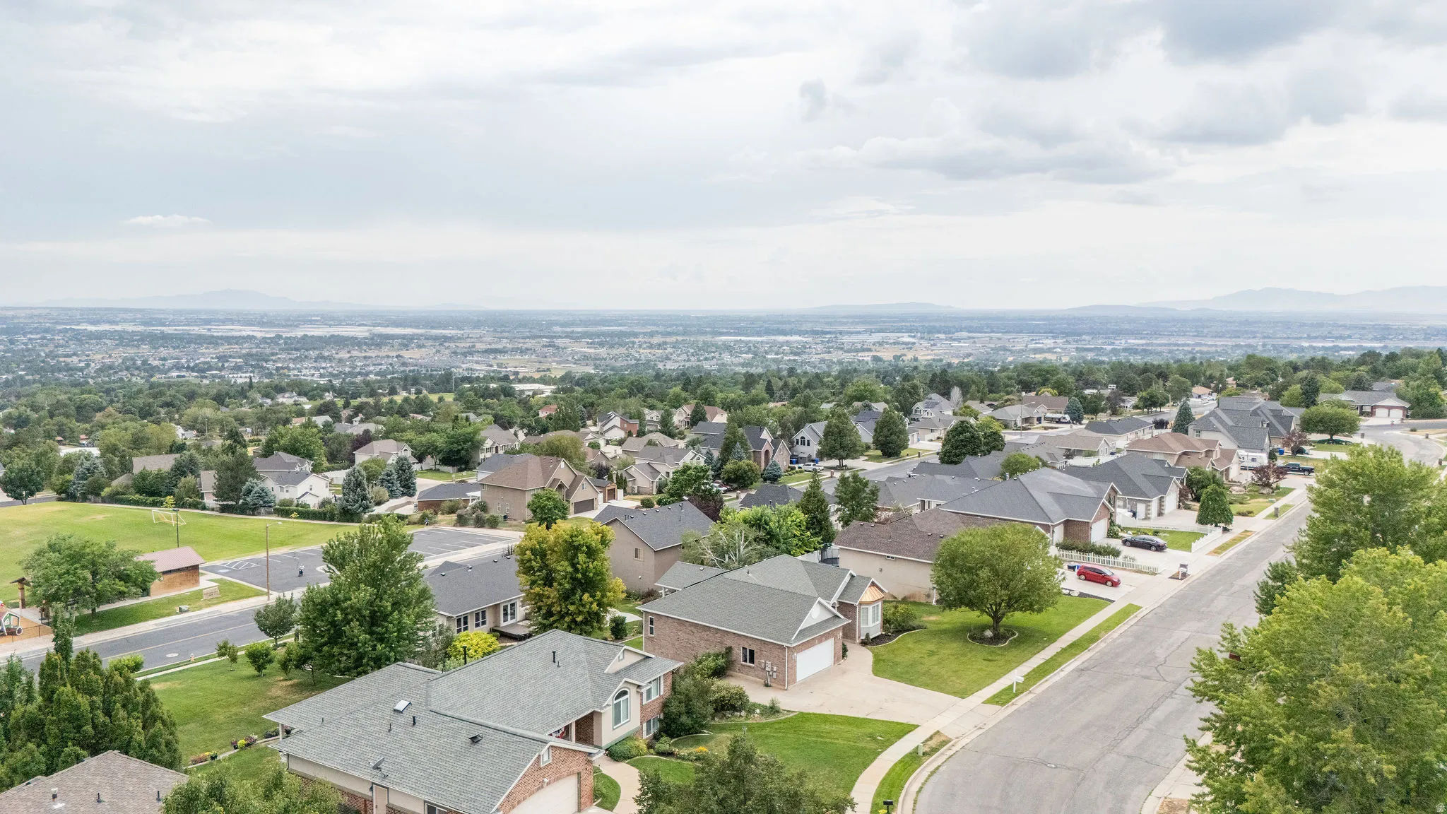 Aerial perspective showcasing a residential neighborhood with varied architectural styles and mature landscaping