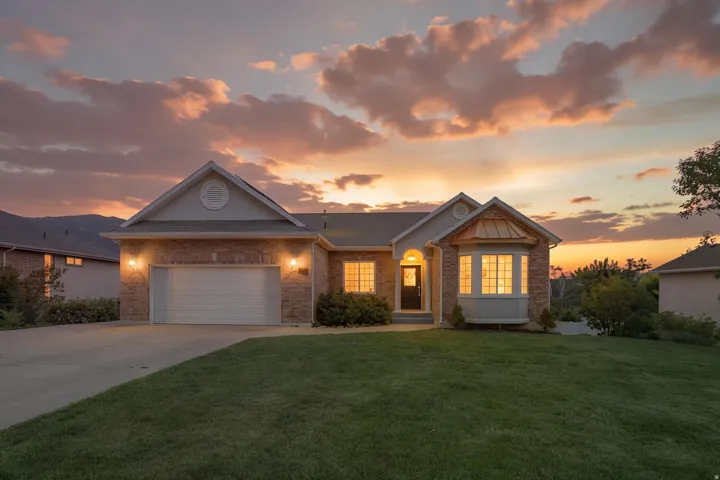 Brick and siding exterior featuring a prominent bay window with a copper-colored roof accent