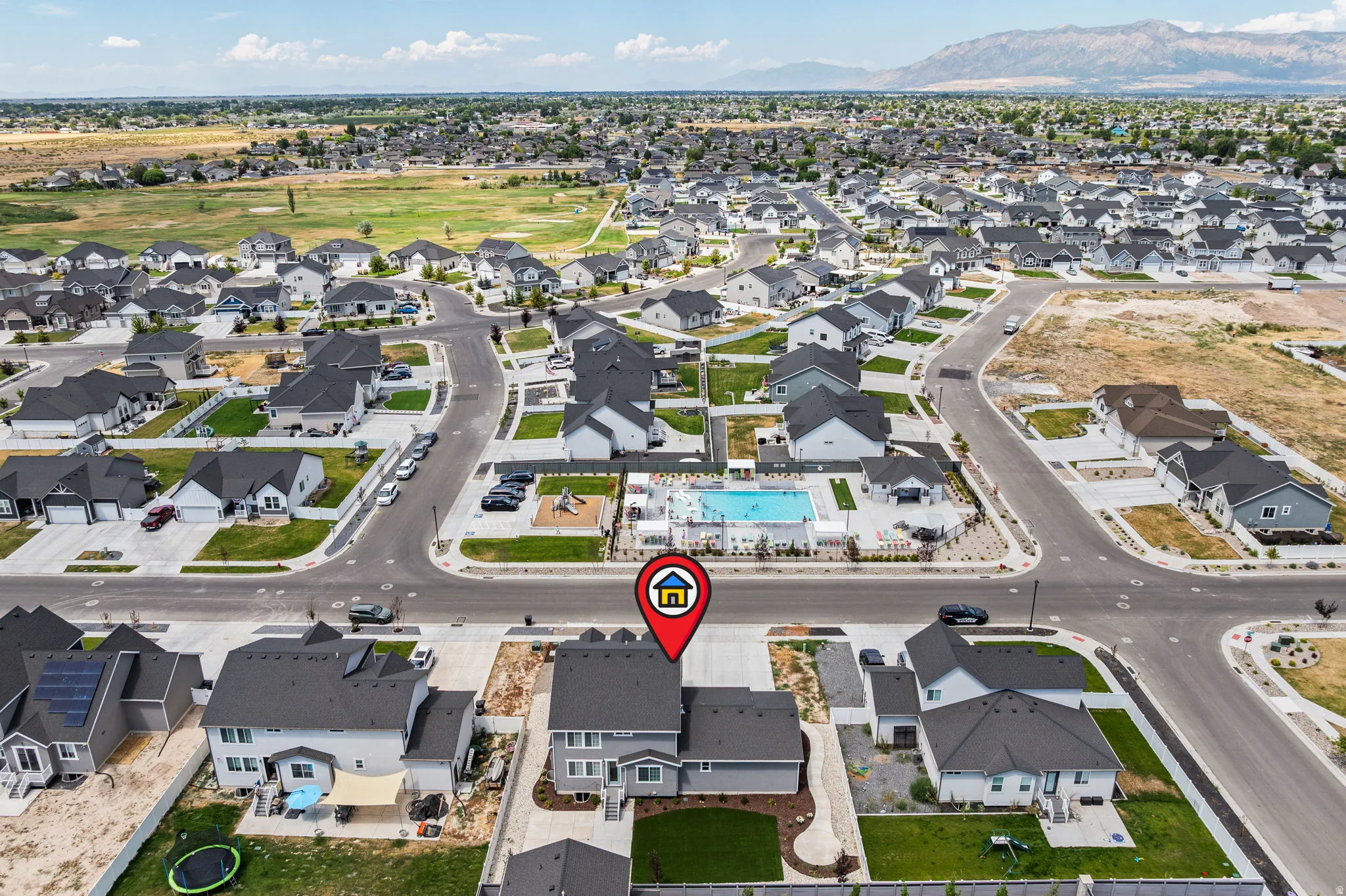 Contemporary residential development featuring a community swimming pool, playground, and paved streets