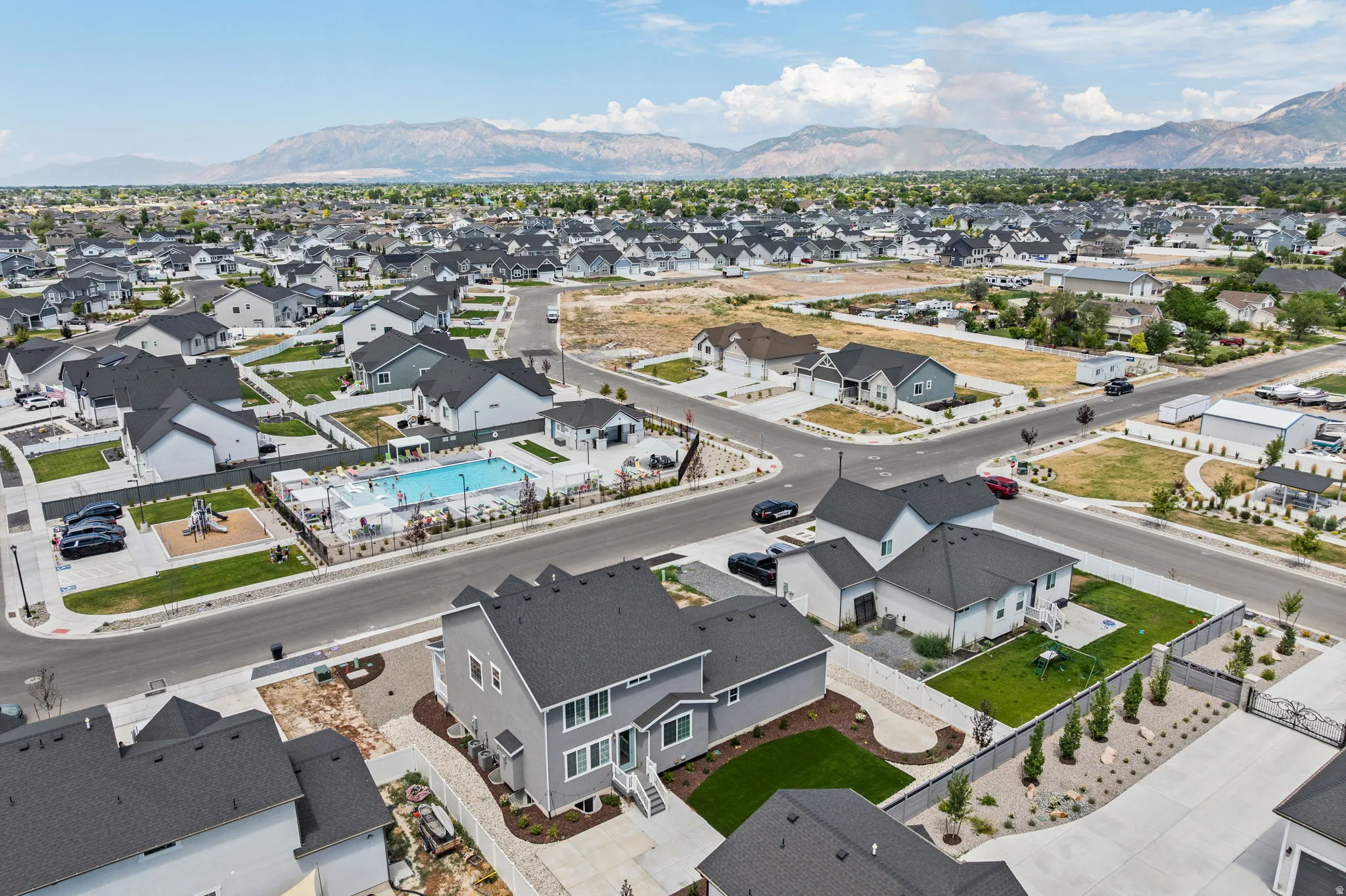 Expansive residential development featuring modern homes with dark roofs and light-colored siding