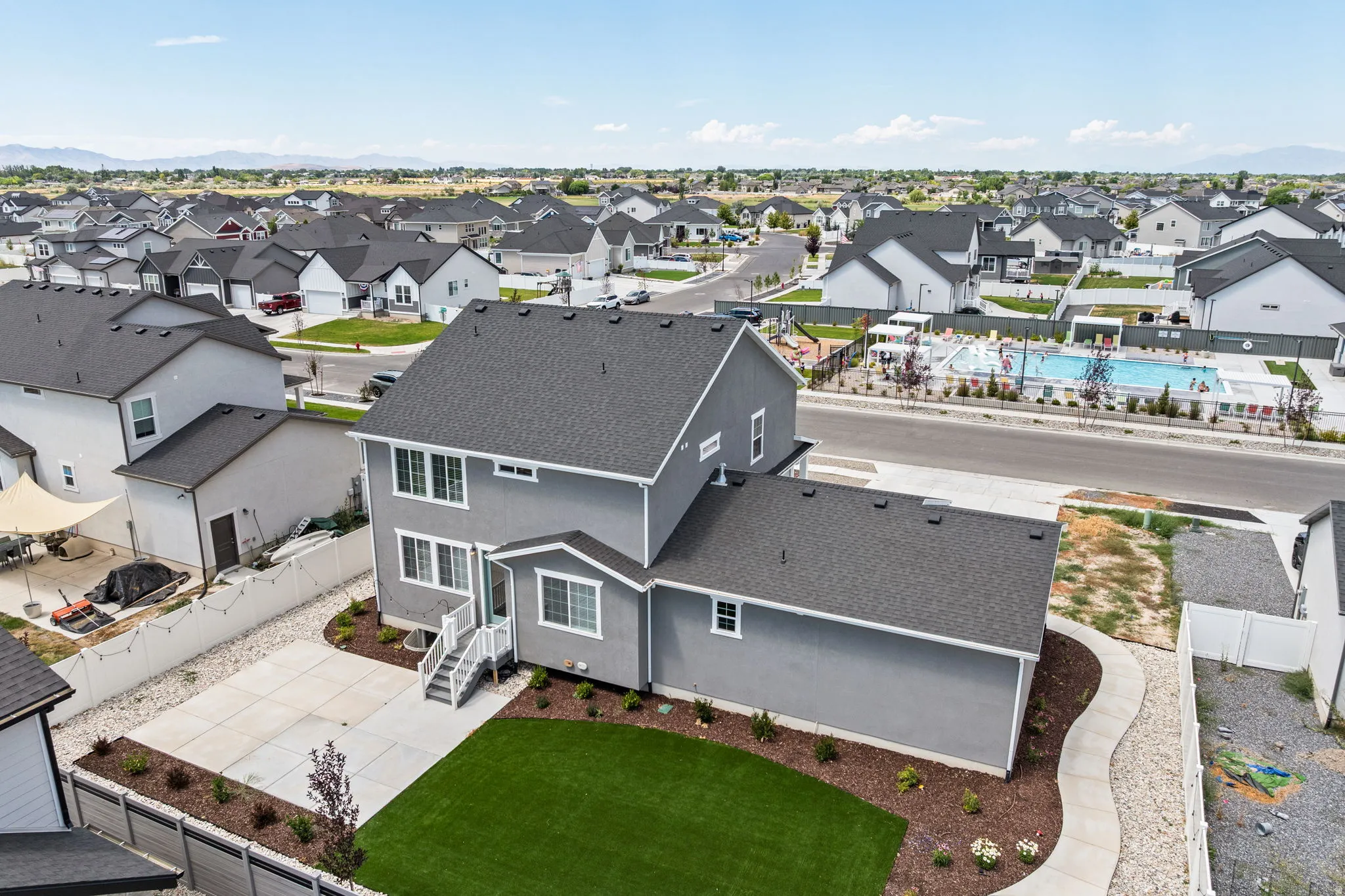 Contemporary two-story residence with a dark gray exterior finish and white trim