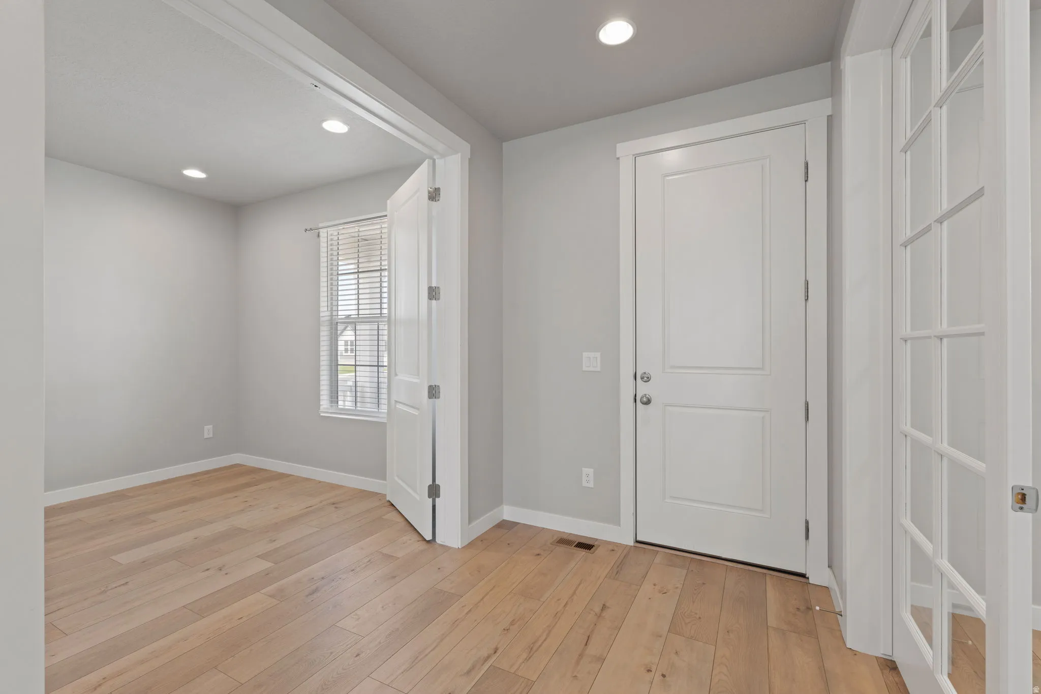 Entryway featuring light wood-finish flooring and recessed lighting