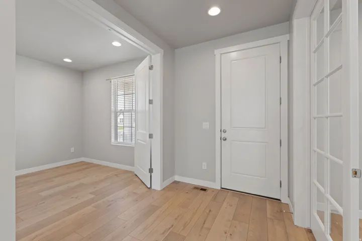 Entryway featuring light wood-finish flooring and recessed lighting