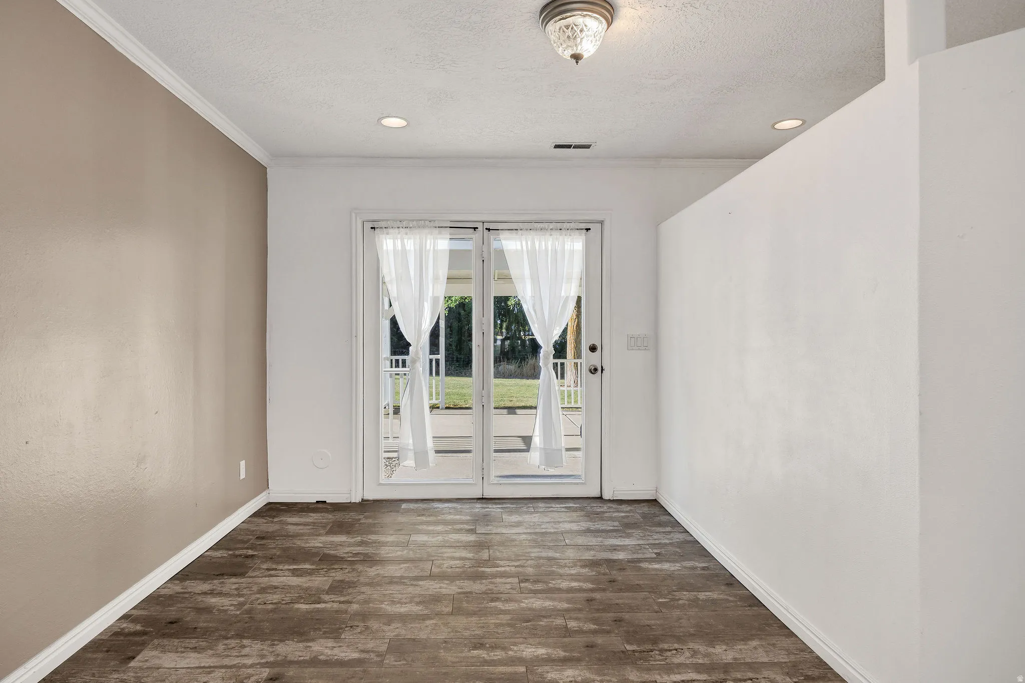 Glass paneled double doors with sheer white curtains
