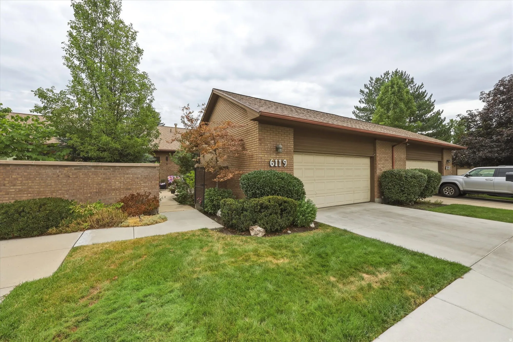 Brick exterior featuring two attached garage doors