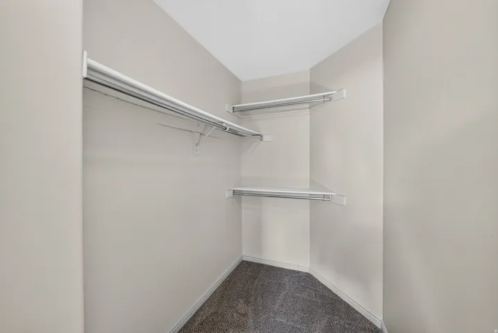 Walk-in closet featuring wire shelving and hanging rods