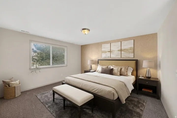 Carpeted flooring, recessed window with horizontal blinds, textured accent wall, and a flush mount ceiling light