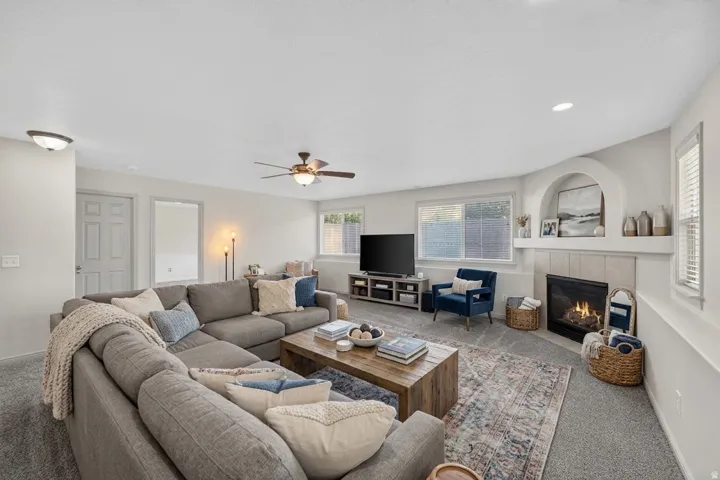 Recessed lighting and ceiling fan complement the broad windows