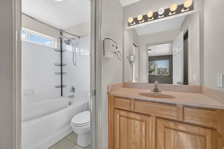 Wood-finish vanity with an integrated sink and light-toned countertop