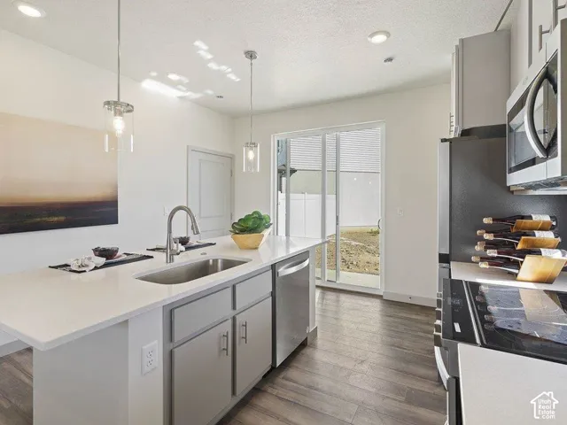 Contemporary kitchen featuring an island with an undermount sink and a gooseneck faucet