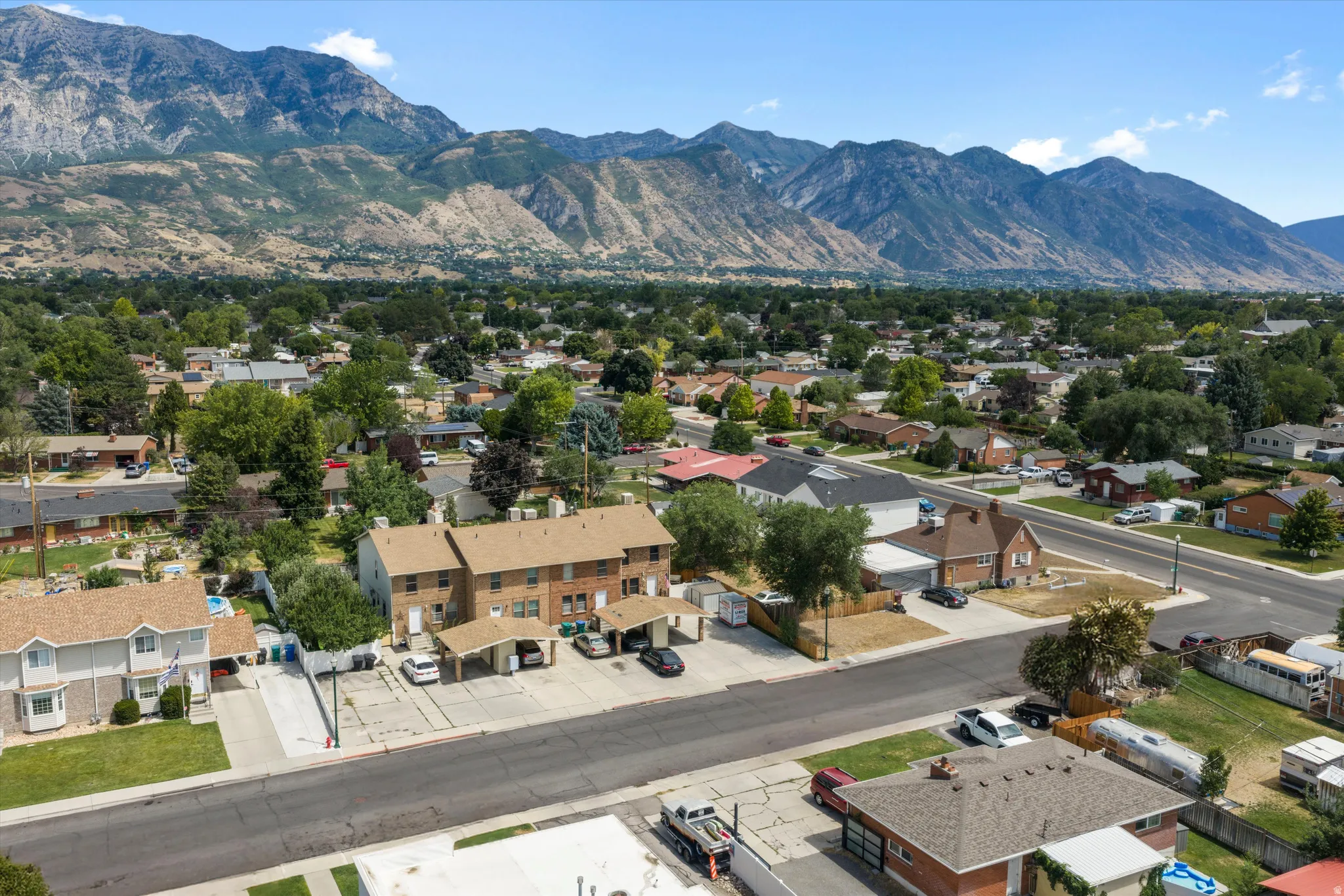Aerial perspective showcasing a residential neighborhood with a prominent mountain backdrop