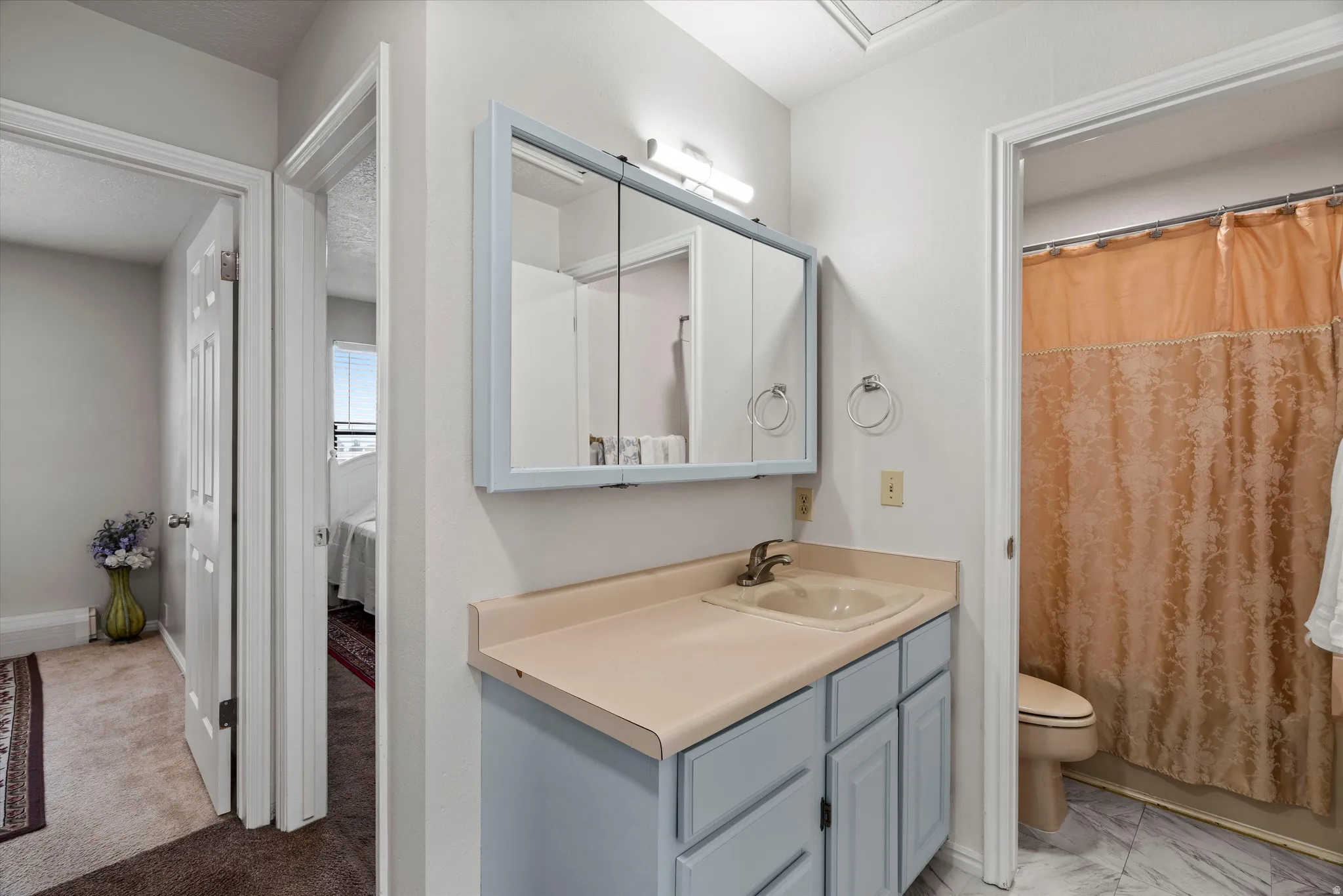 Bathroom vanity featuring a medicine cabinet, integrated sink, and light blue cabinetry
