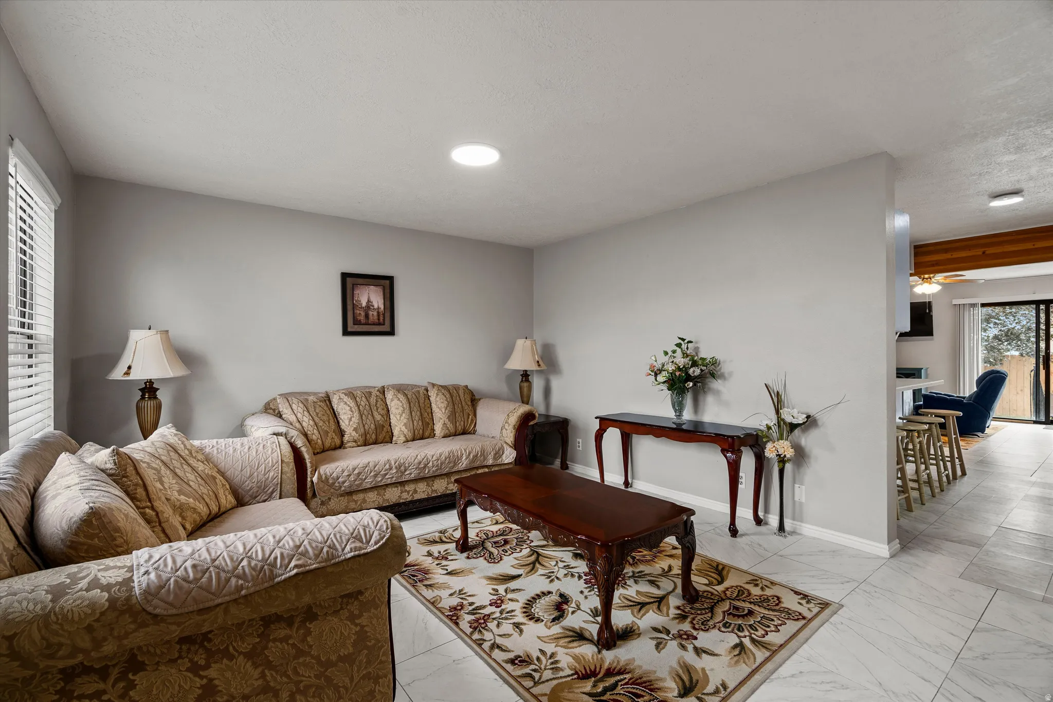 Living area featuring light gray walls, white-finish flooring, and a recessed ceiling light