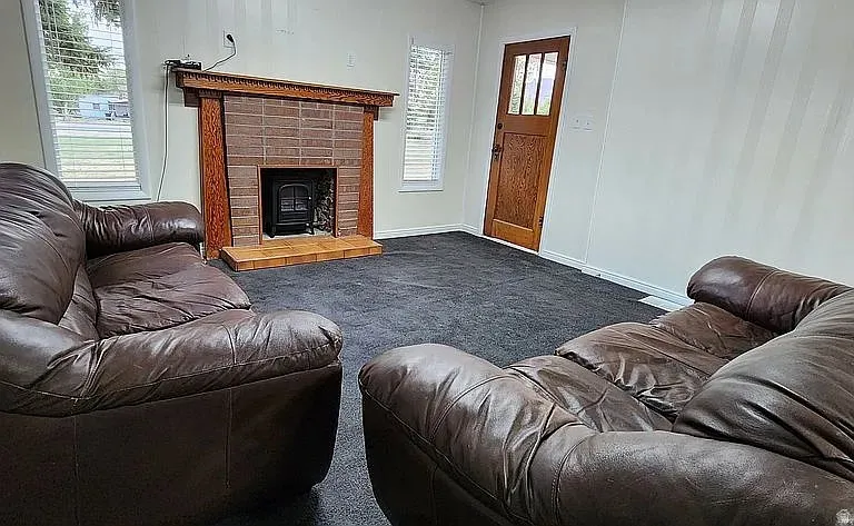 Living area featuring dark gray carpeting and light-toned walls