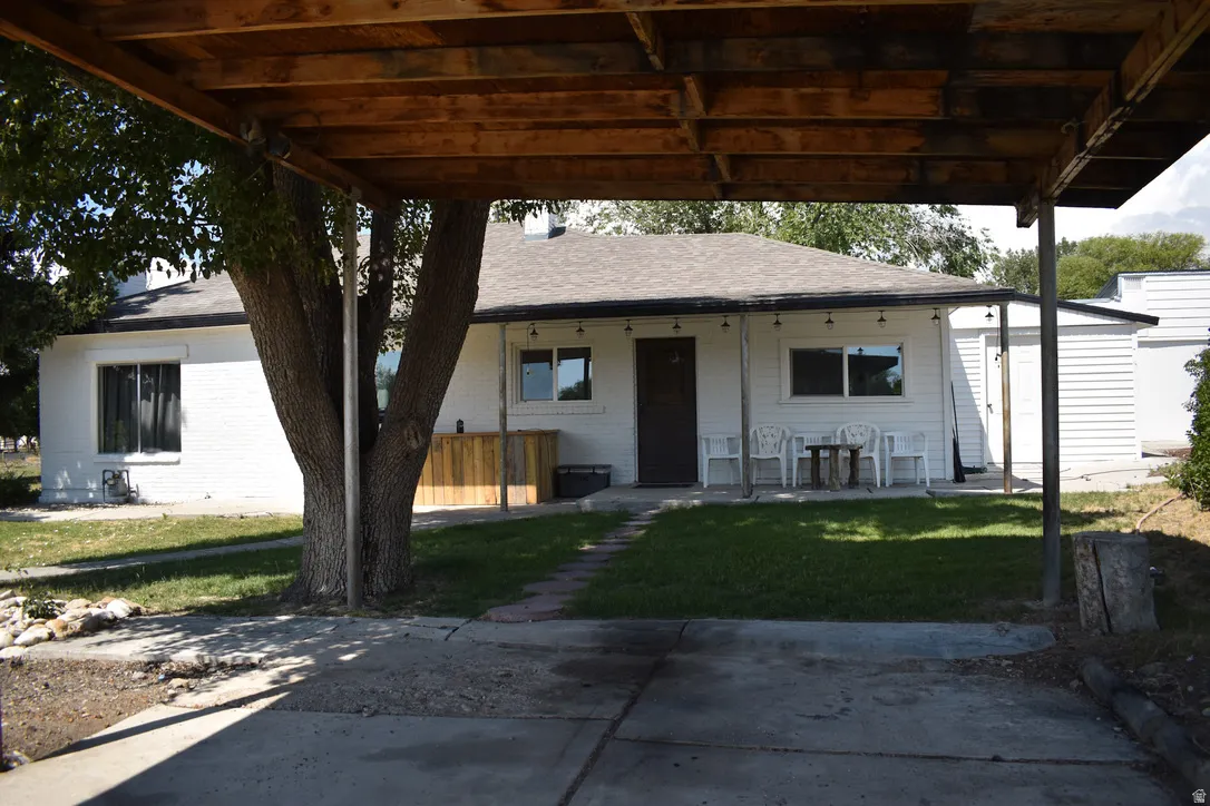 Carport with wood framing and a concrete driveway