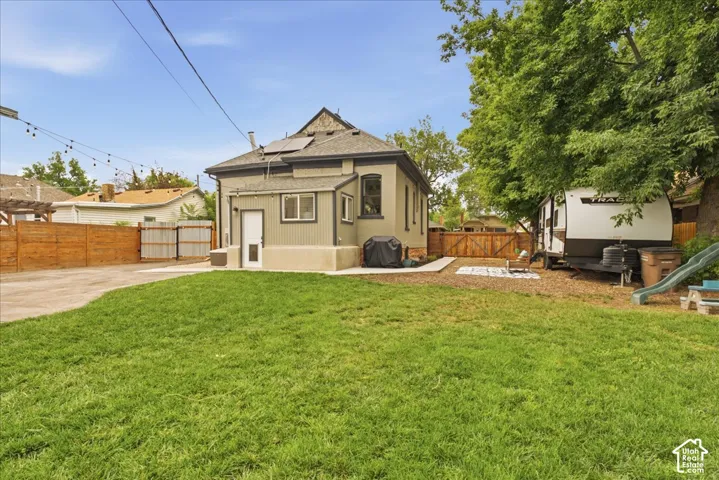 Expansive green lawn with a privacy fence bordering the property