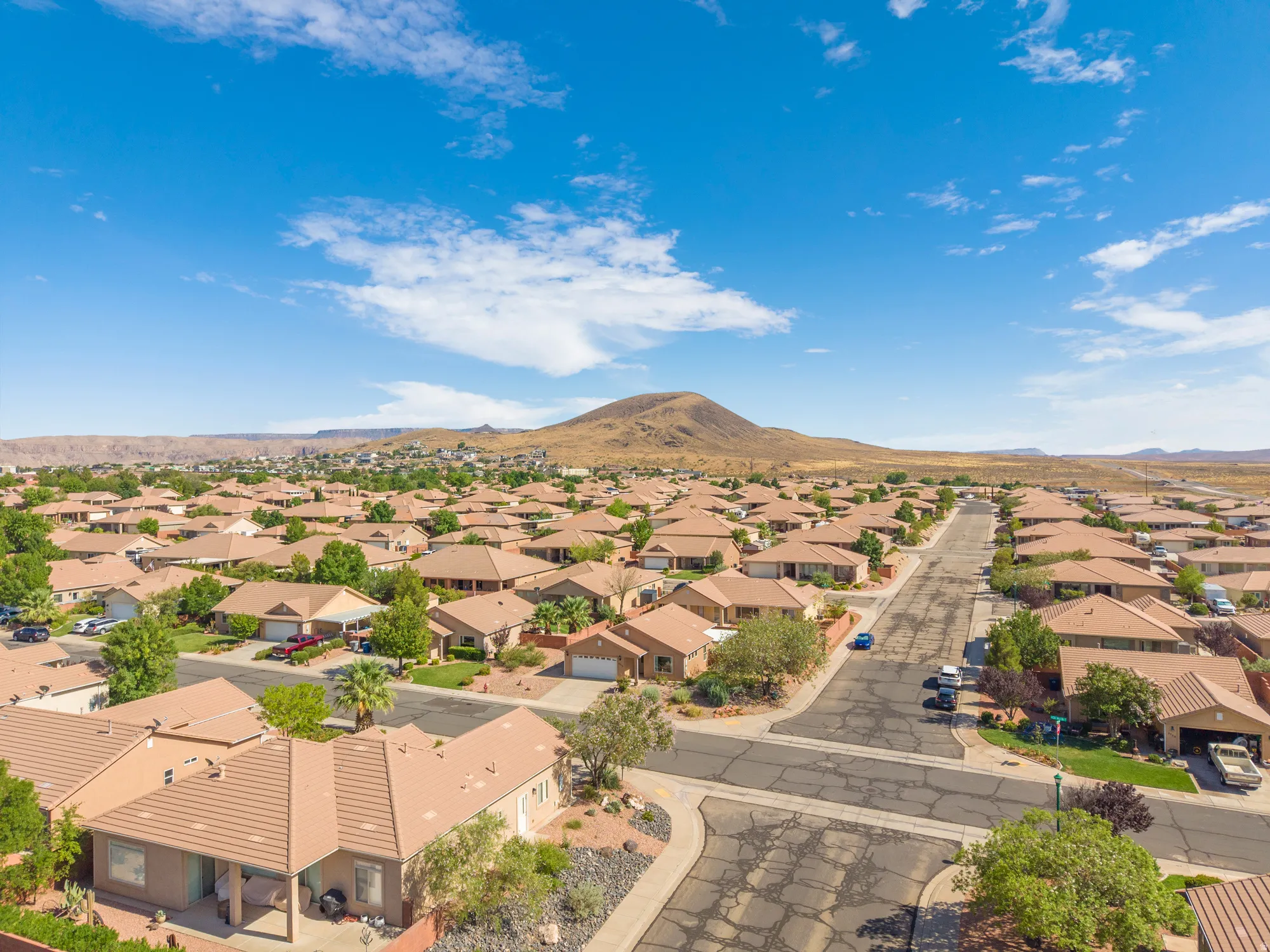 Aerial perspective showcasing a residential area with a prominent mountain backdrop