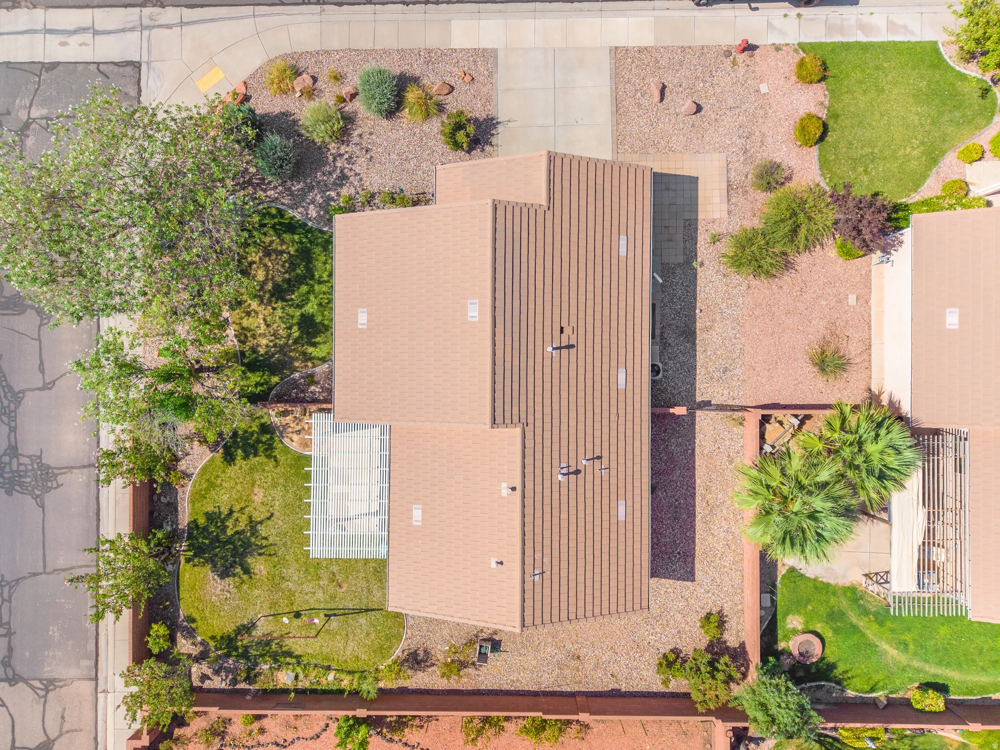 Aerial perspective showcasing a property with a distinct roofline and diverse outdoor spaces