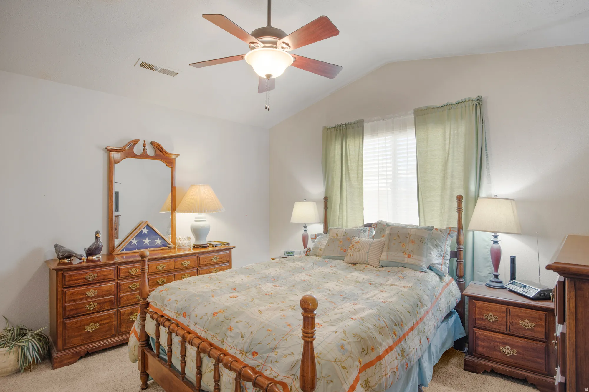 Room featuring a vaulted ceiling and an overhead ceiling fan with integrated lighting