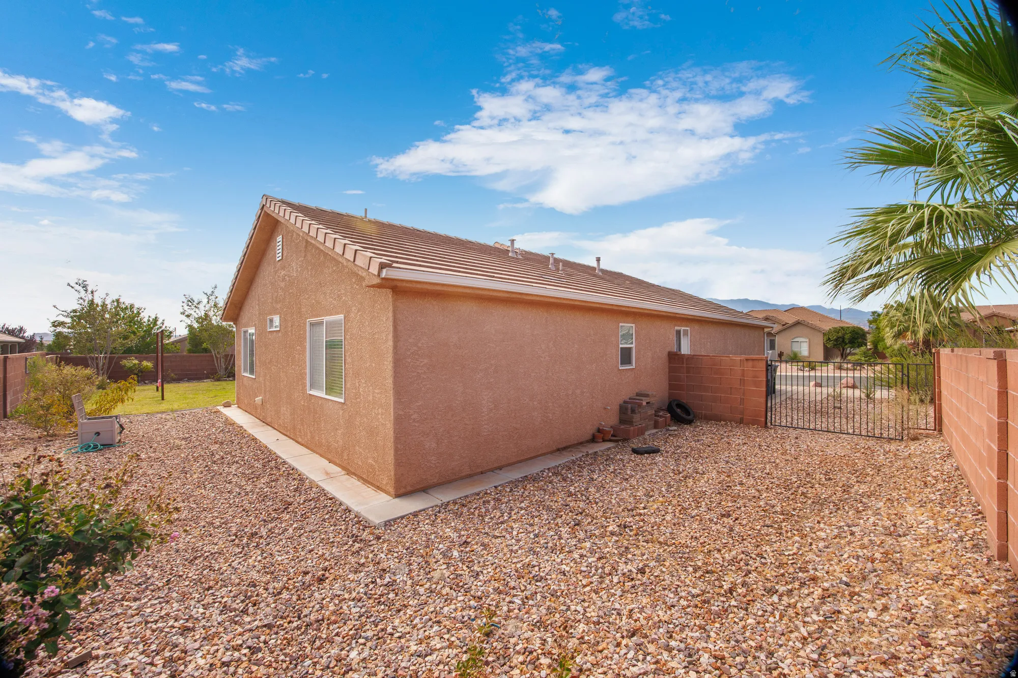 Exterior stucco siding with a tile roof