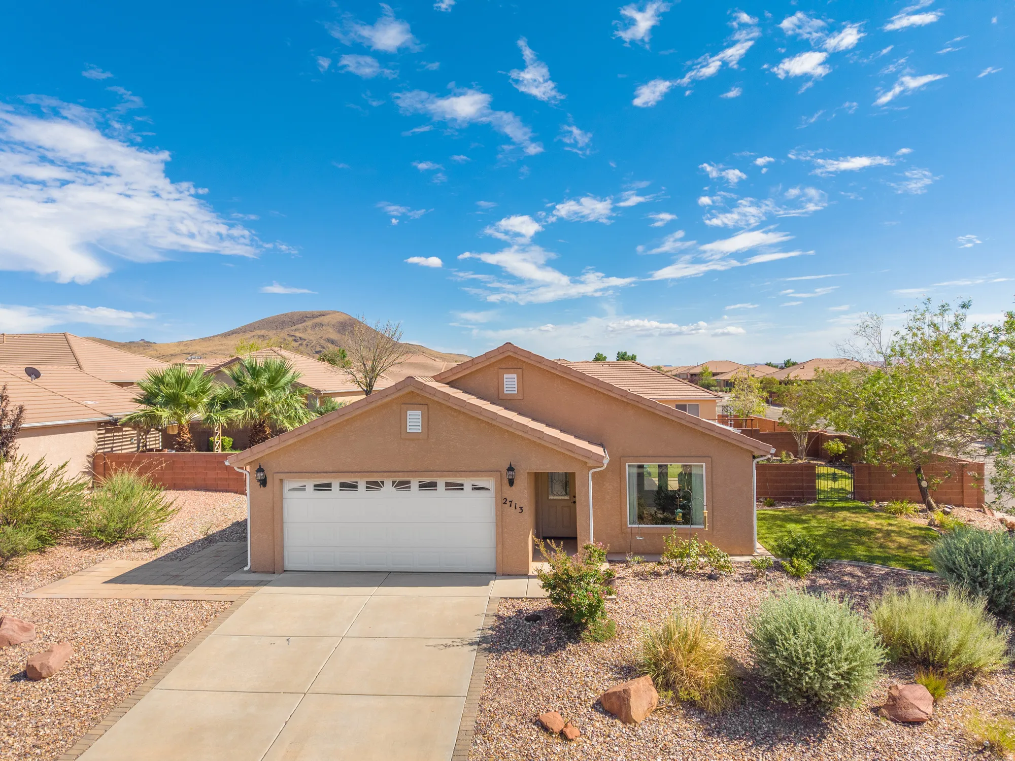 Single-story residence featuring a two-car garage and a paved driveway