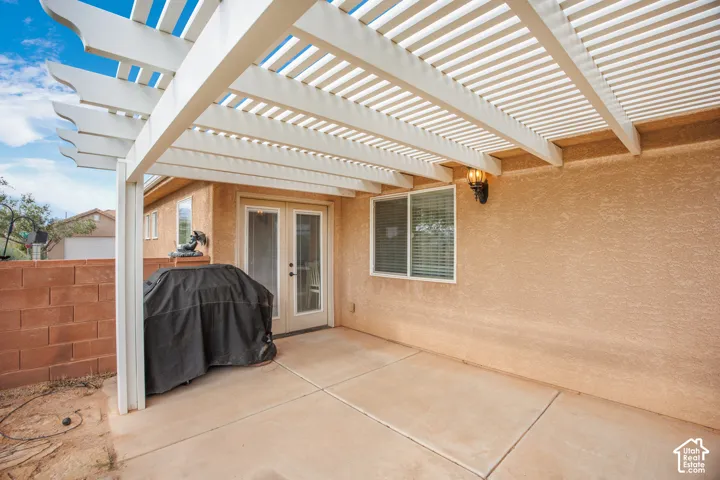 Covered patio space featuring a white lattice pergola