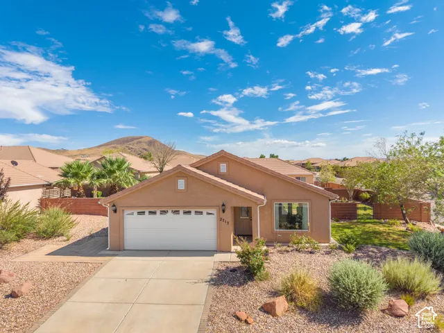 Single-story residence featuring a two-car garage and a paved driveway
