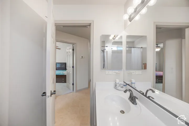 Bathroom vanity featuring an integrated sink, brushed nickel faucet, and dual mirrored medicine cabinets