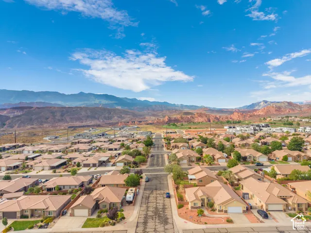Expansive neighborhood setting featuring a diverse collection of single-story residences, paved streets, and arid landscaping