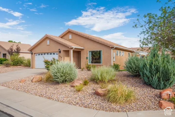 Stucco exterior residence with a two-car garage and a tile roof