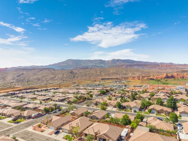 Expansive aerial capture showcasing a residential community set against a backdrop of distant mountains
