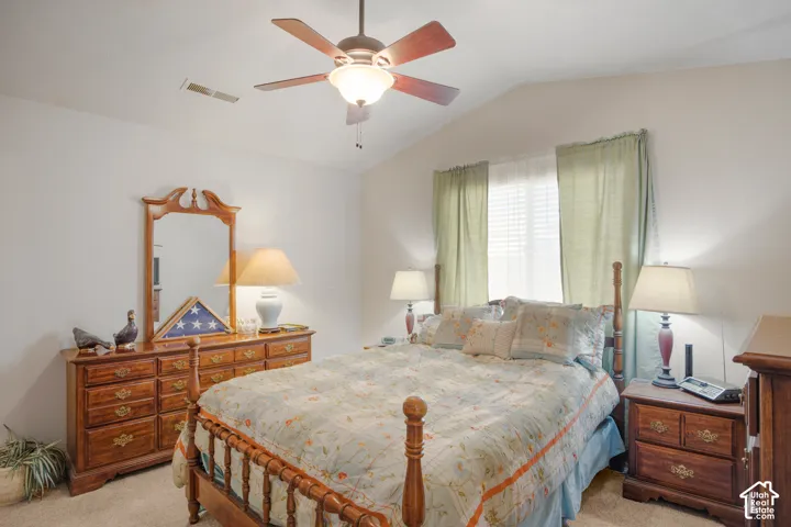 Room featuring a vaulted ceiling and an overhead ceiling fan with integrated lighting