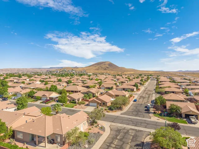 Aerial perspective showcasing a residential area with a prominent mountain backdrop