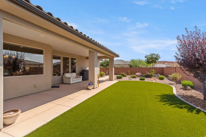 Covered patio with integrated lighting, a concrete slab, and stucco exterior