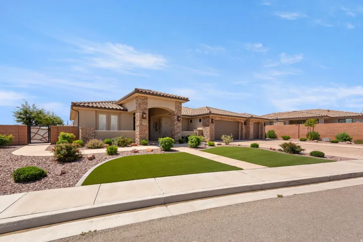 Tuscan-style residence featuring a stucco exterior, stone facade accents, and a tile roof