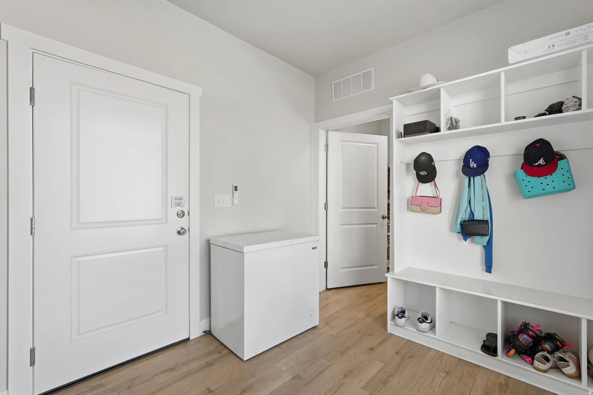Entryway mudroom featuring built-in storage with hooks and cubbies