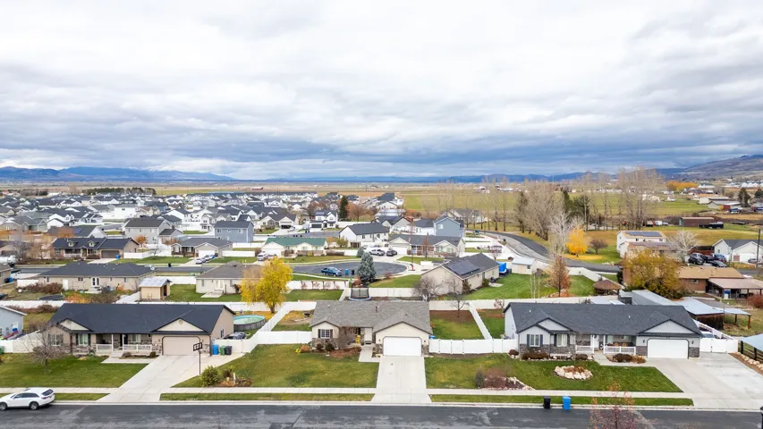 Established residential neighborhood featuring single-story homes with attached garages, paved driveways, and landscaped front yards