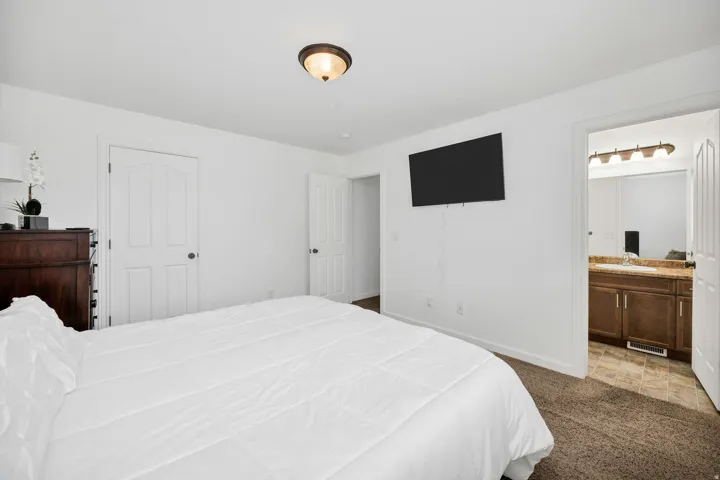 Bedroom space featuring a recessed light fixture and carpet flooring