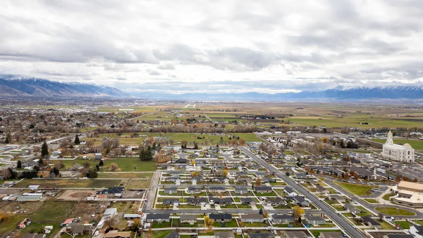 Expansive aerial perspective showcasing a residential neighborhood with distant mountains