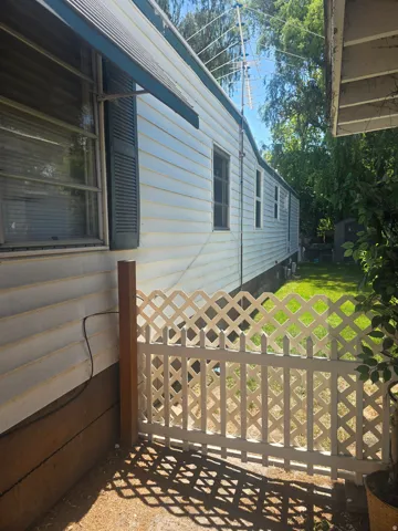 Exterior siding with louvered shutters and window awning