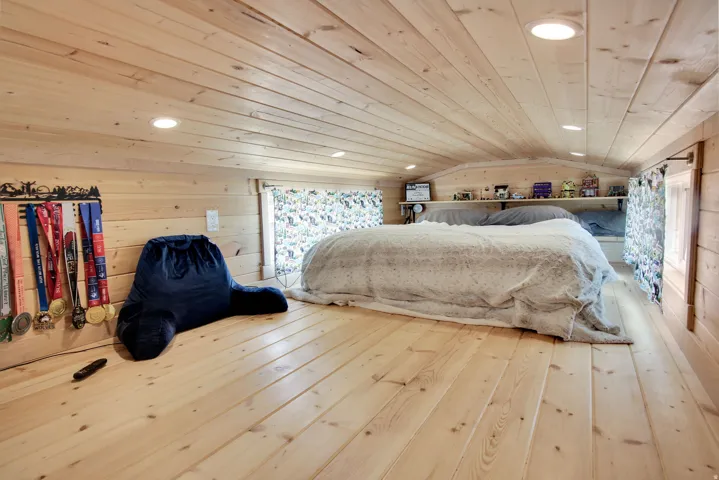 Loft space featuring wood-finish plank flooring and ceiling