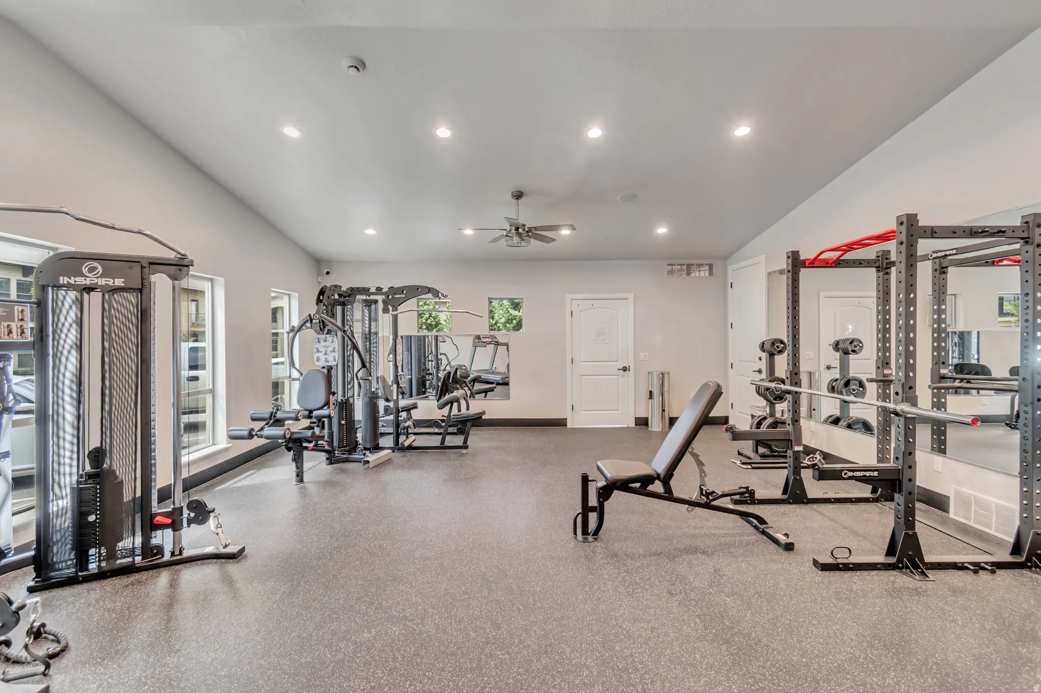 Dedicated fitness area featuring a vaulted ceiling and recessed lighting