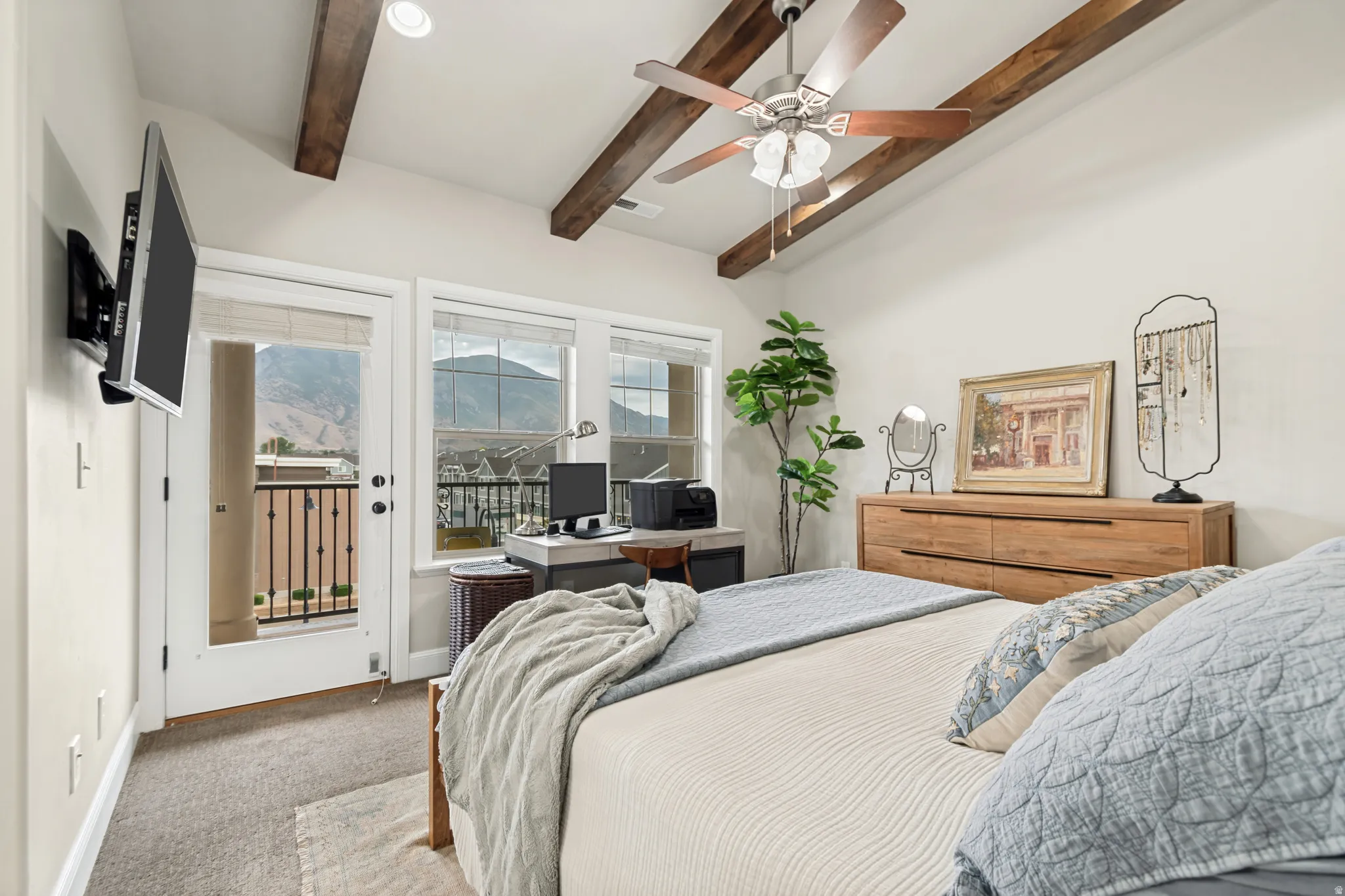 Vaulted ceiling with exposed wood beams and recessed lighting