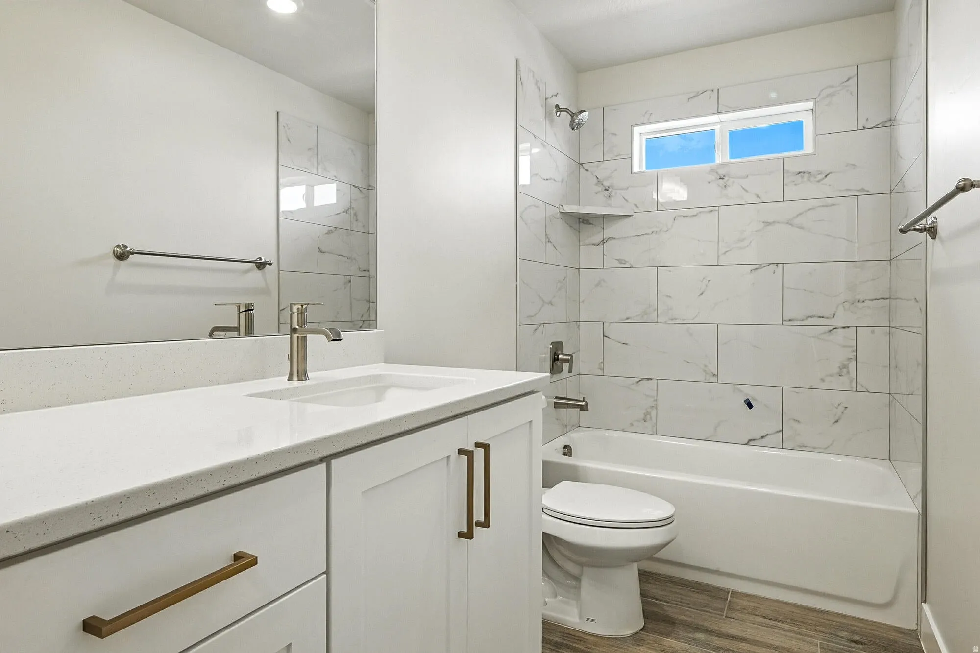 Bathroom featuring a white vanity with bronze hardware, a white countertop, and an integrated sink