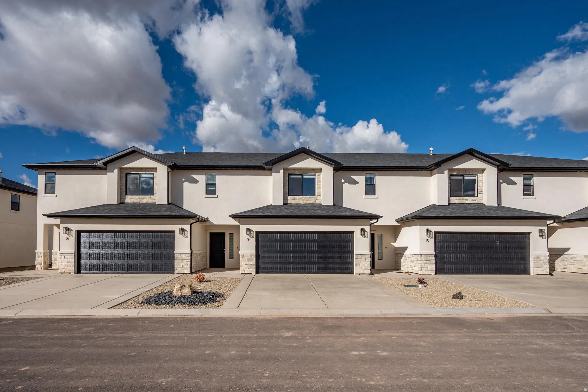 Contemporary multi-unit exterior with stucco finish and stone accents