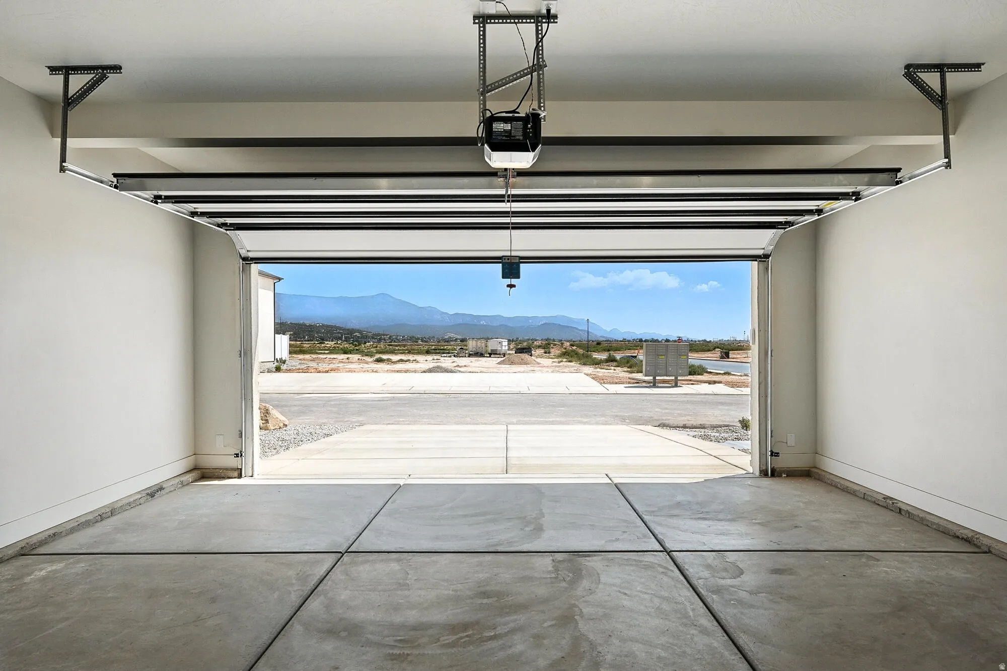 Spacious garage with an automatic door opener and concrete flooring