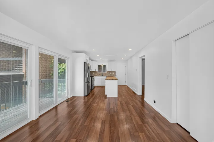 Expansive main living area featuring wood-finish flooring and recessed lighting