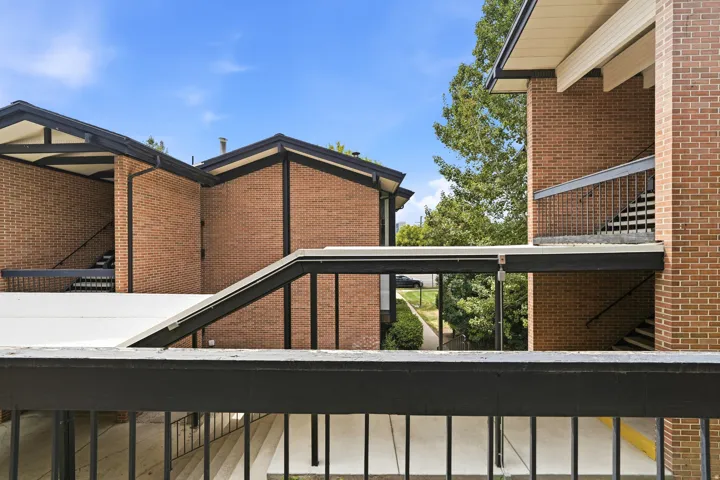 Exterior brick facade featuring black trim and pitched roofs